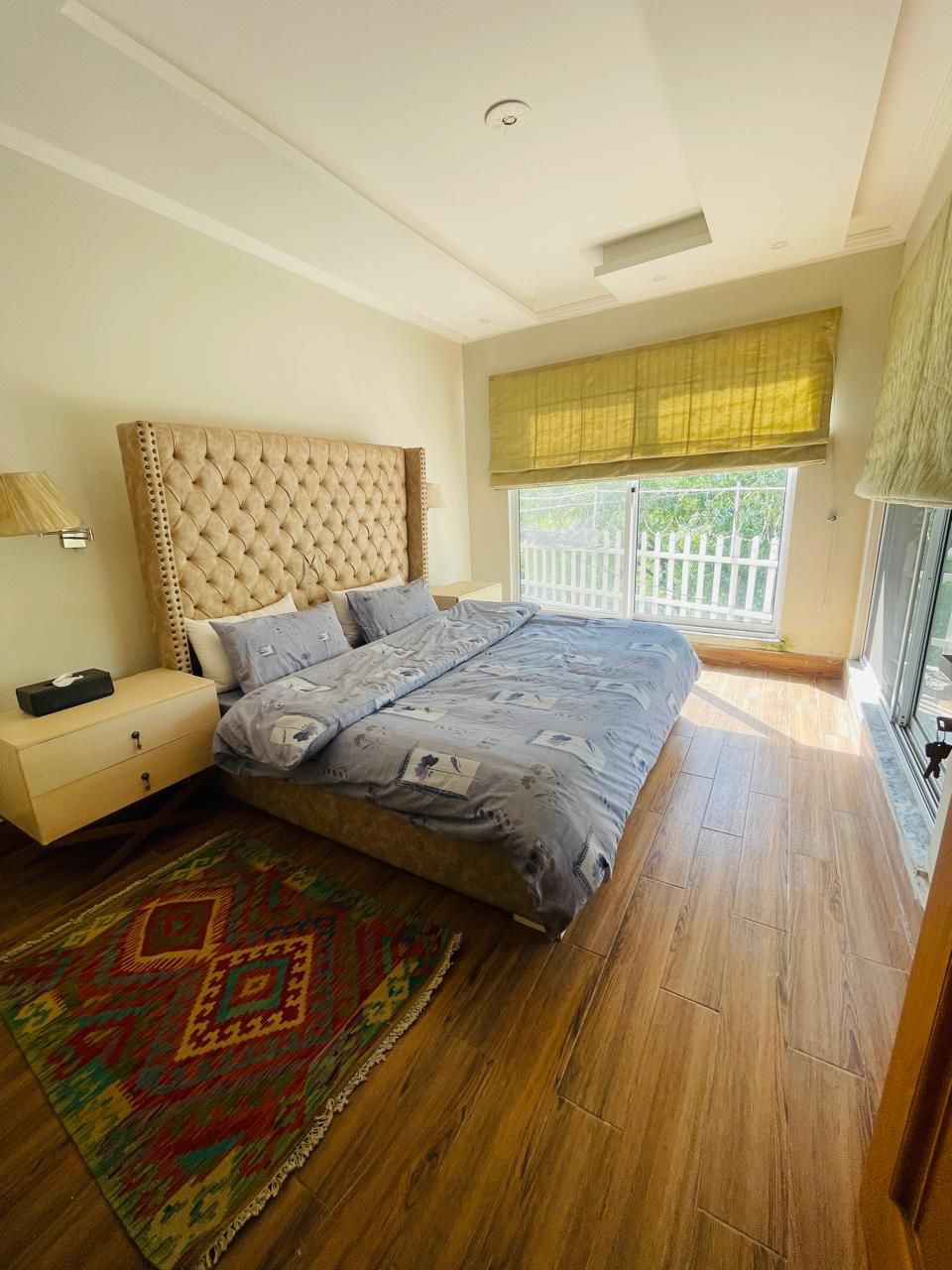 cottage balcony terrace with dual-sided panoramic views, outdoor seating, mountain and garden vista, peaceful atmosphere