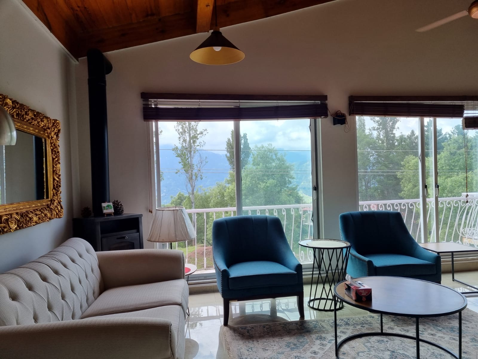 cottage outdoor deck with comfortable seating, mountain panorama view, evening ambiance